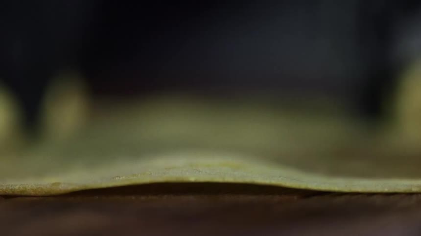 A tortilla is rolled flat on the table