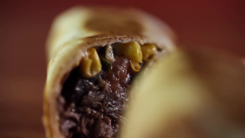 A burrito being cut in half