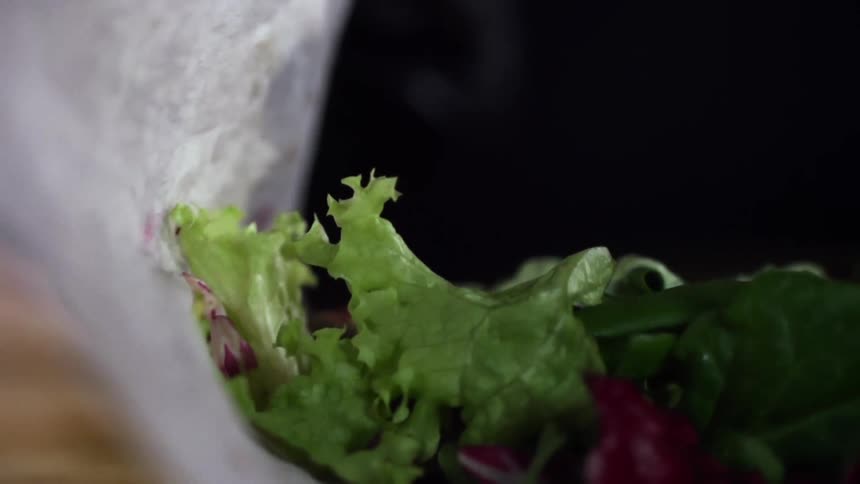Vegetables are rolled up in a tortilla to make a wrap