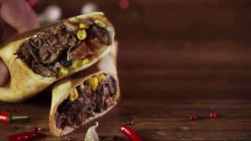 A food wrap is placed on a wood surface