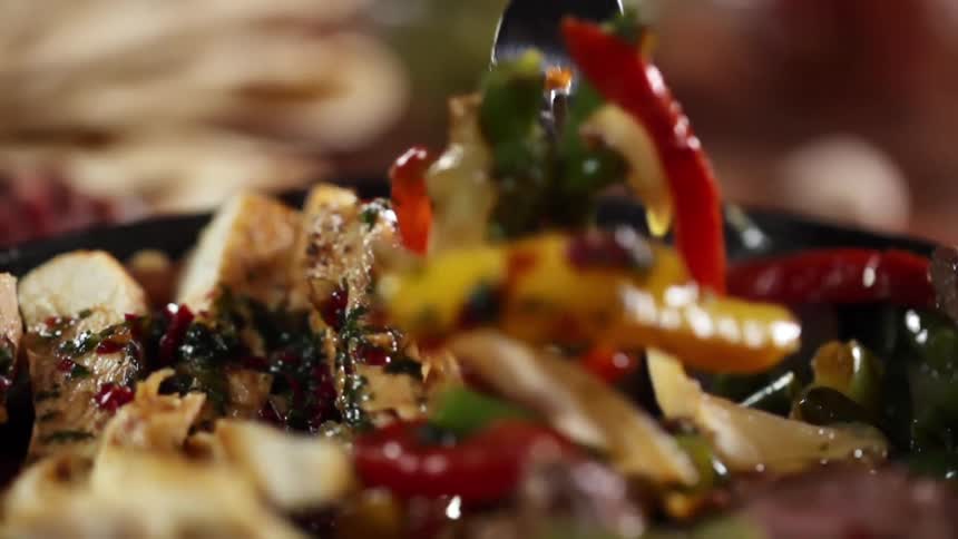 A fork digging in to a dish of food
