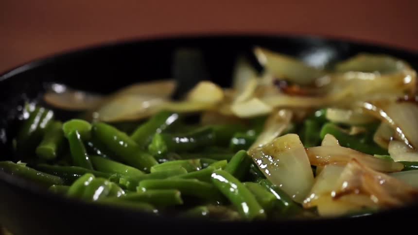 Cooked onions and vegetables in a bowl