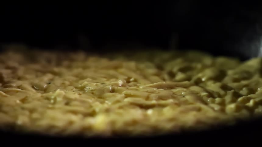 Food sits in a black bowl