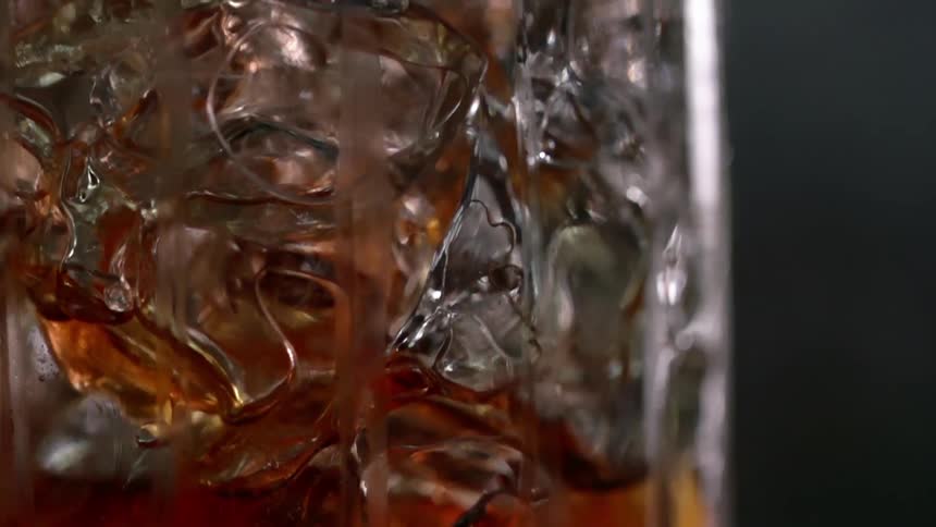 Cocktail is mixed into a glass jar with ice cubes