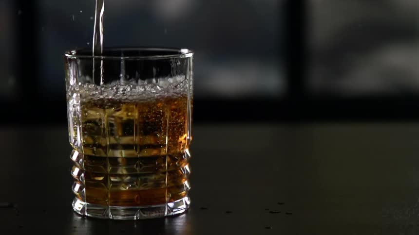 A whiskey being poured into a glass