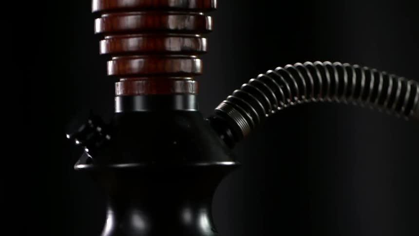 A hookah has a hose and metal valve