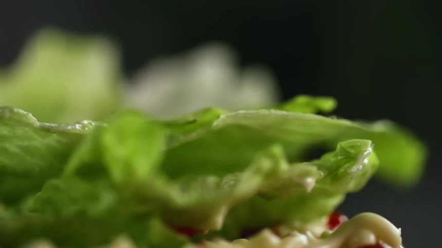 A lettuce leaf bounces up as it is dropped on another
