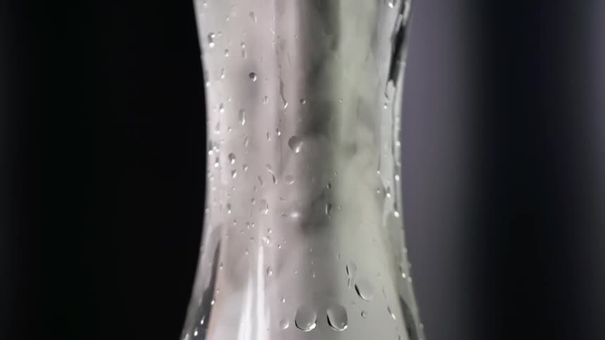 Smoke rising inside a glass hookah's base