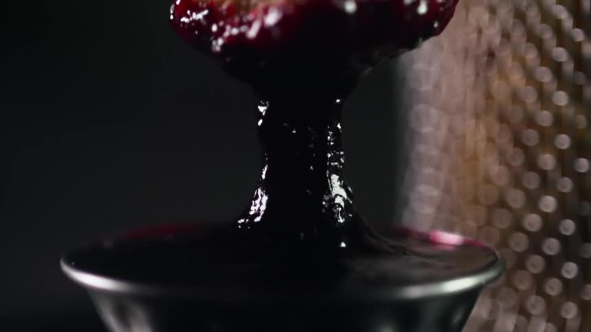 Bread being dipped in cranberry sauce
