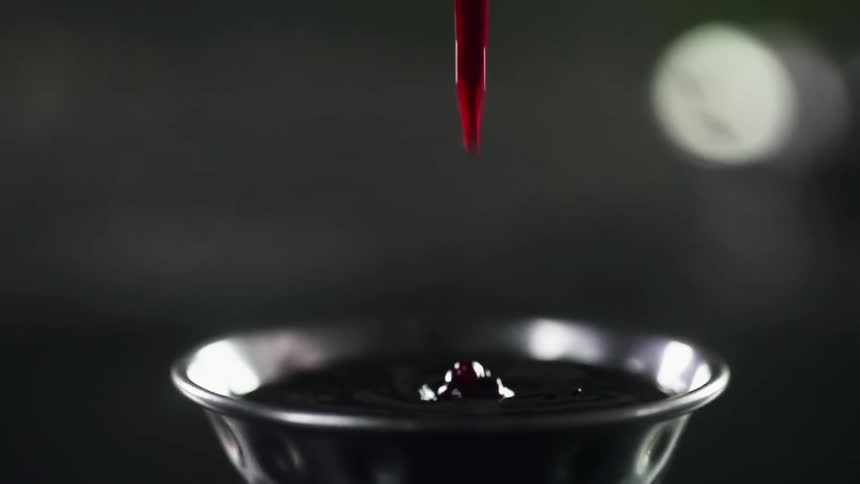 Cranberry sauce being poured into a bowl
