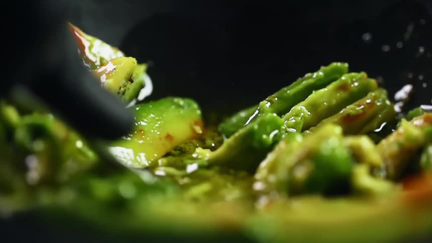 A person smashes avocado with a fork