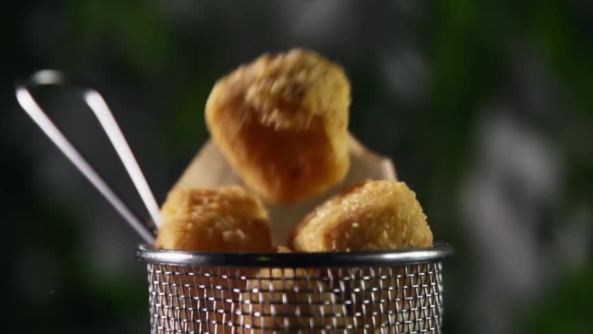 Nuggets are dropped into small metal mesh basket with handle