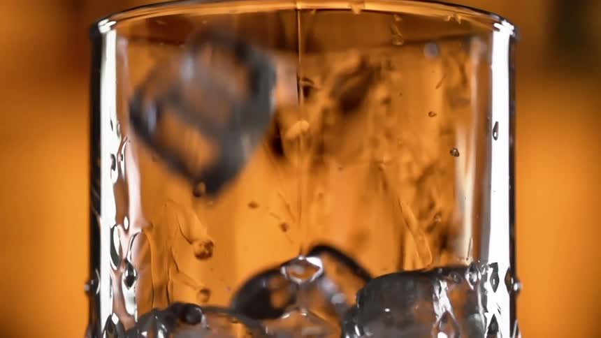 Ice falling in to a glass