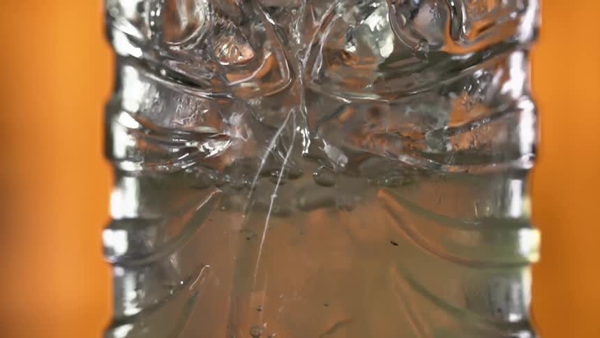 A liquid being poured into a glass with bubbles