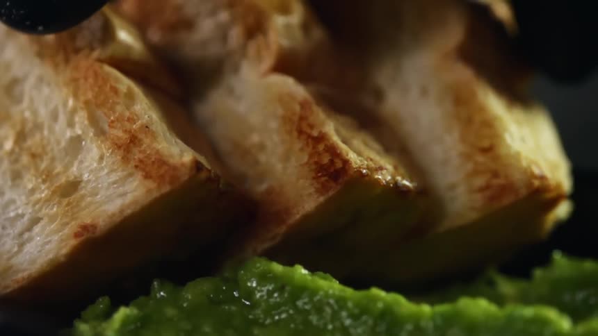 Toasted bread is placed by a guacamole
