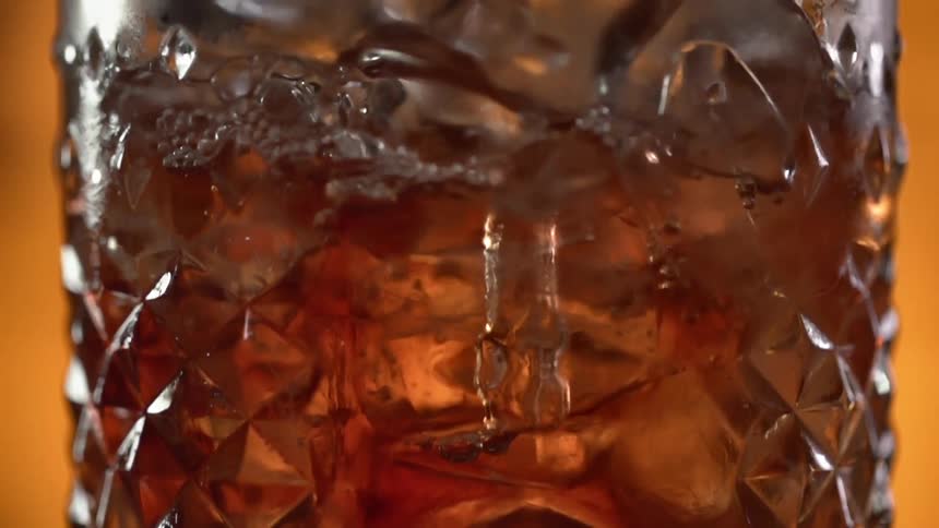 Liquid fills a glass filled with ice