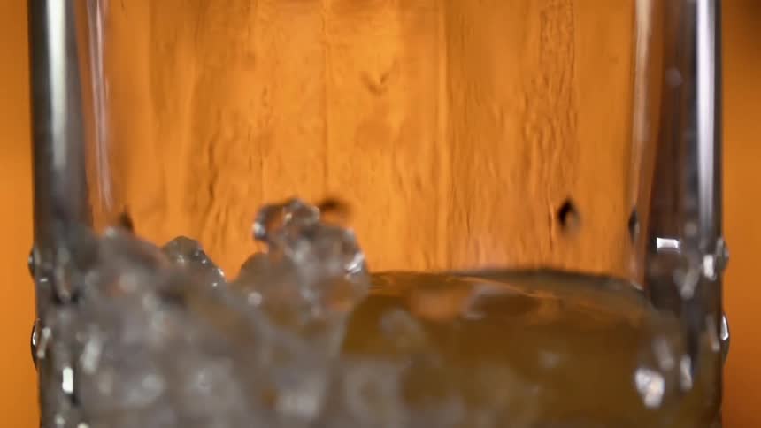 A drink being poured in to a glass