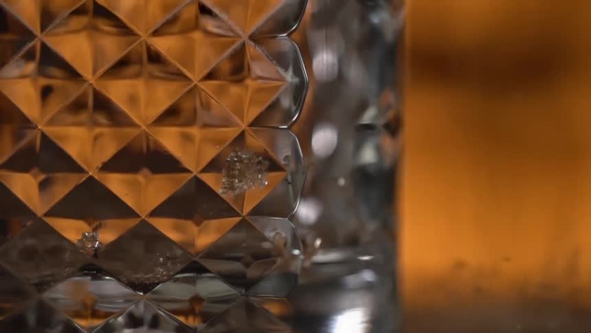 Dust particles falling down near a cristal glass
