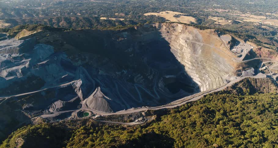Aerial view of a canyon with cars parked at the top of it
