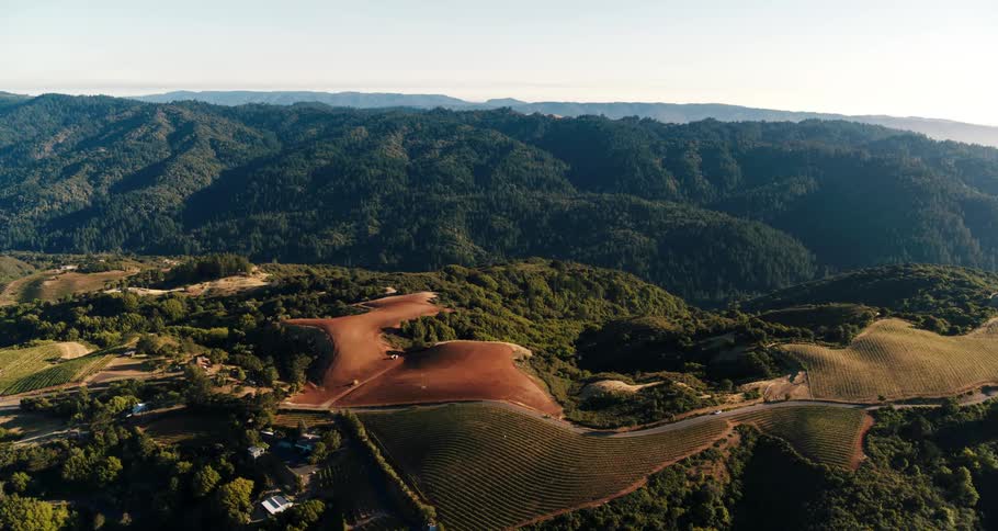 Assorted buildings and fields sit in a mountain valley