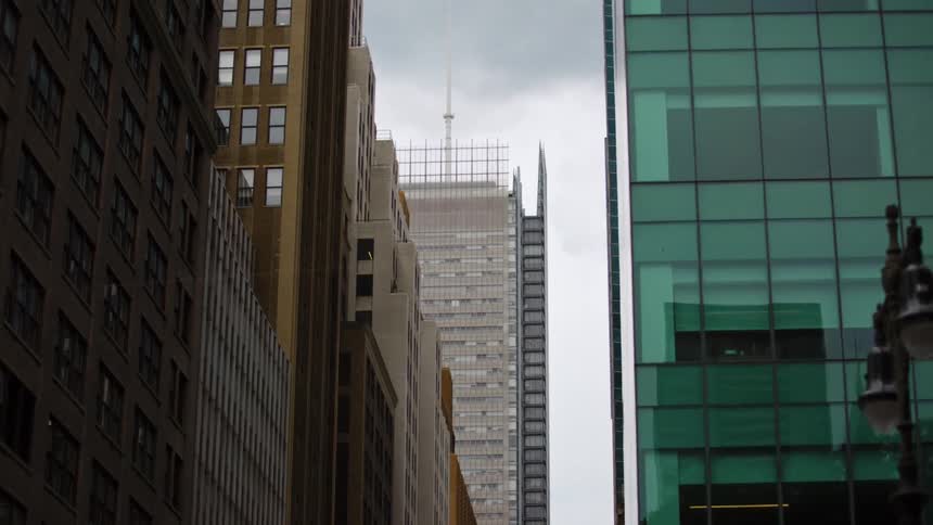 A city with streetlights buildings and skyscrapers with the sky and clouds in the background