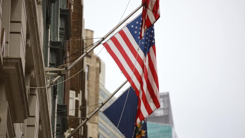 American flags hang from the side of a city building