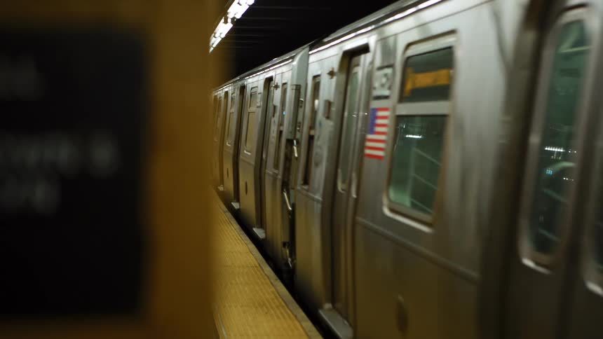 Subway train carrying people arrives at underground station