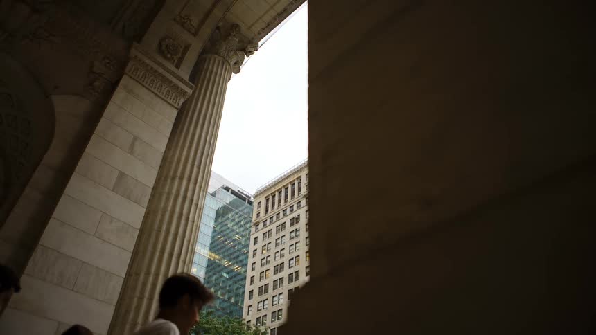 People walk out of a building entrance in a downtown area