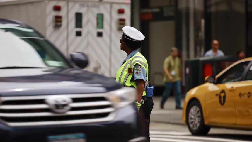 New york city traffic enforcement agent directing traffic on a busy street