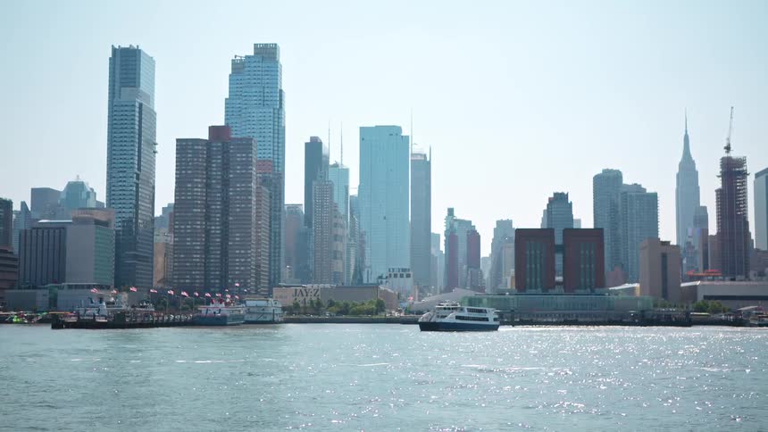 A yacht sails from the city ahead