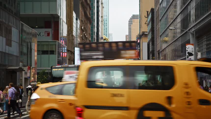 Pedestrians walking on a zebra crossing in a busy intersection in the city