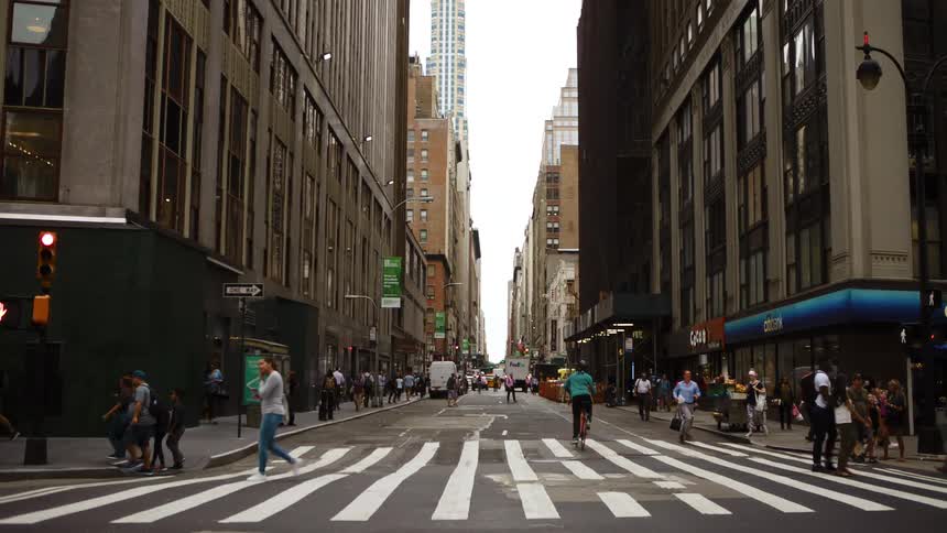 People use the zebra crossing on an intersection in the citys downtown