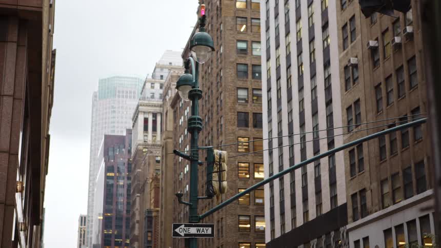 City street with tall office buildings and apartments in downtown on a cloudy day