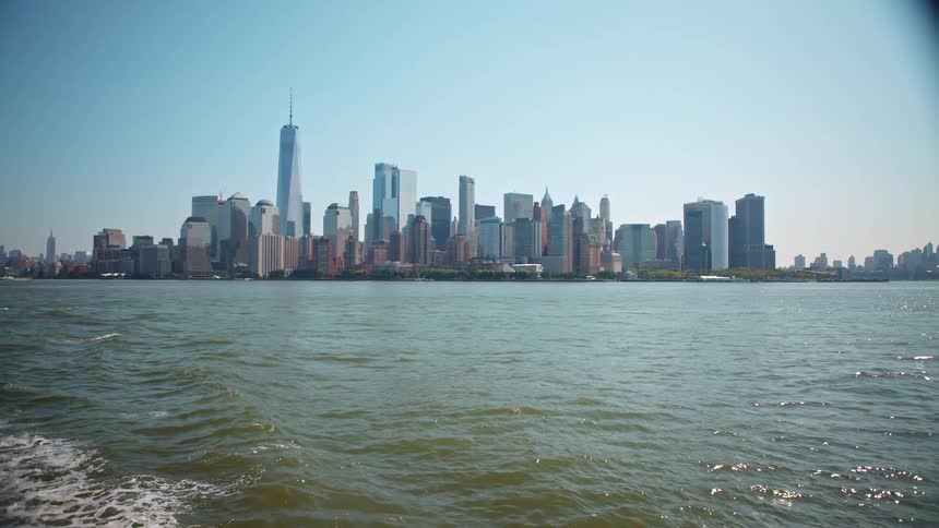 Small waves in the ocean off the coast of a metropolis during the day