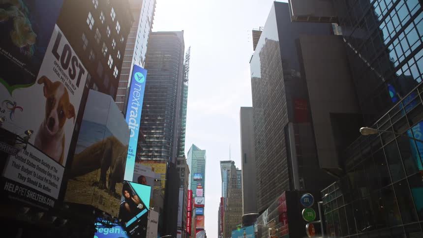 City street with tall buildings and billboard in downtown