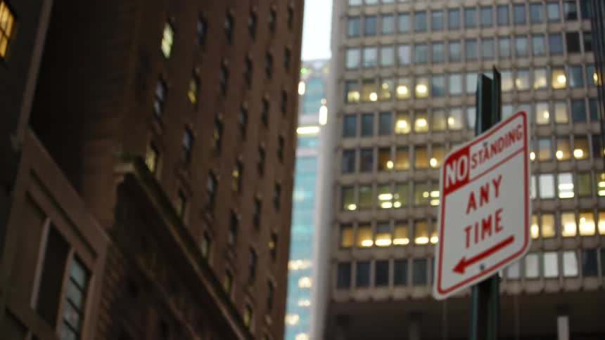 A street sign sits in front of the building
