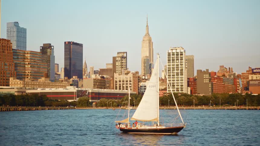A boat and jet ski ride past the city