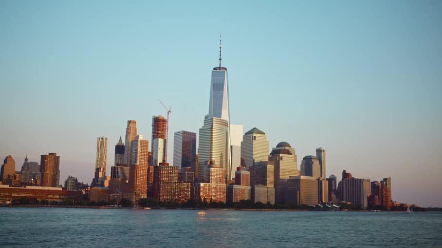A river with a city skyline with buildings and skyscrapers in the background