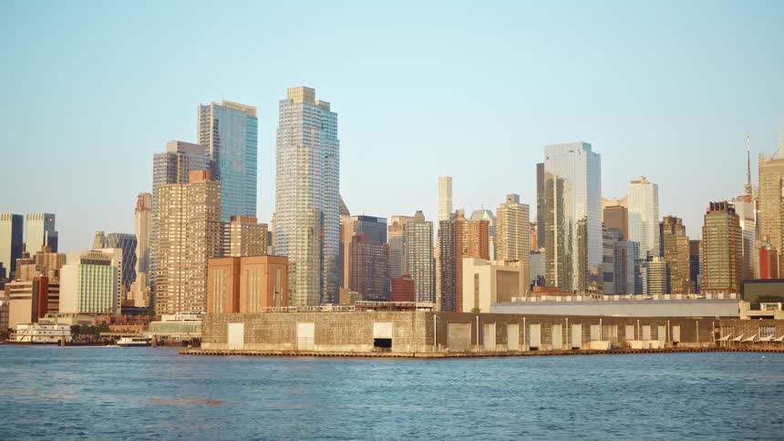 Big city skyline from a distant with tall buildings seen from the river