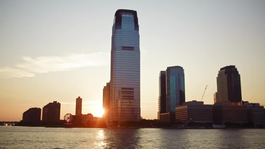 A skyscraper on the coast of a city looms over the ocean