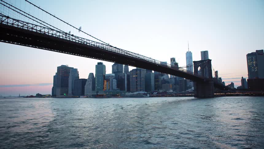 Brooklyn bridge over the river in new york city at sunset