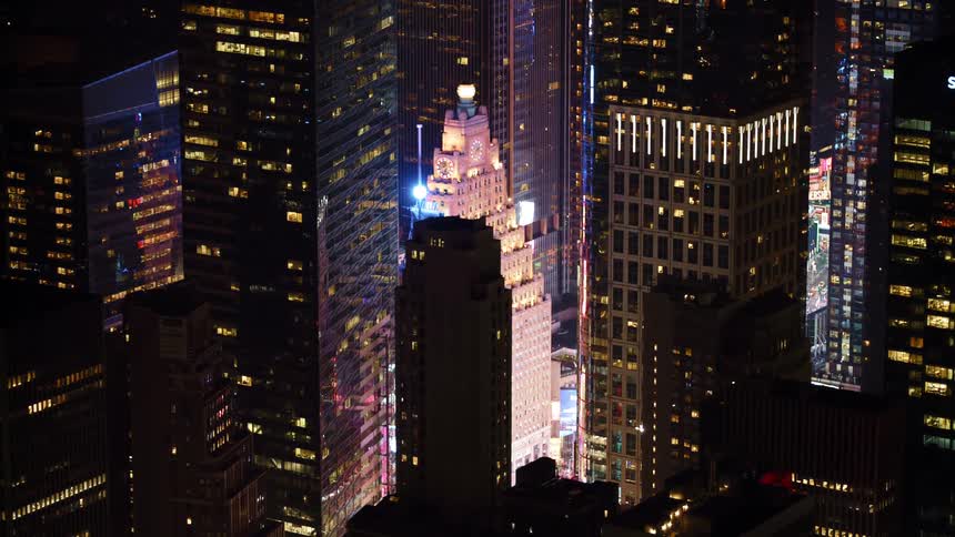 Aerial view of illuminated tall buildings in downtown at night