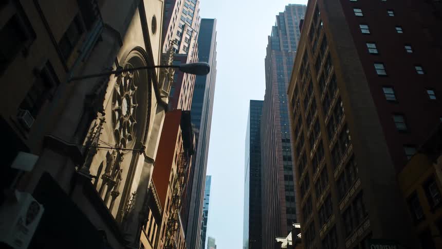 City street with high rise office buildings and shops in downtown on a sunny day