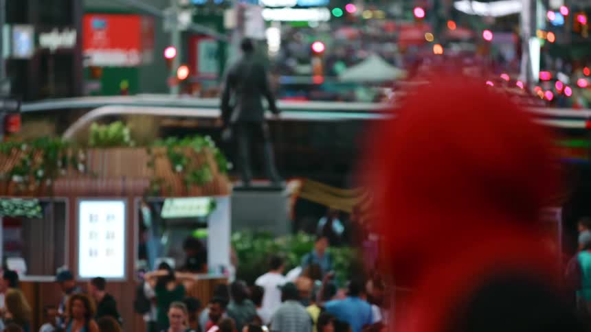 A large mass of people gather in a large city