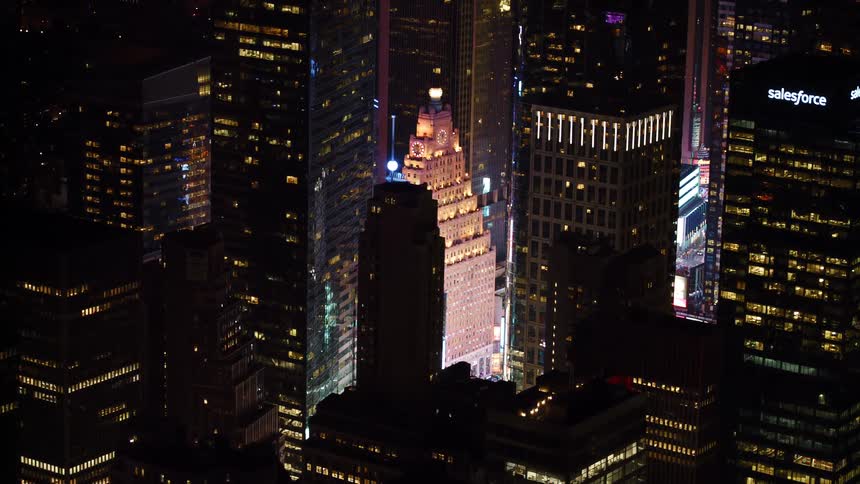 A city with buildings and skyscrapers at night with lights from the windows