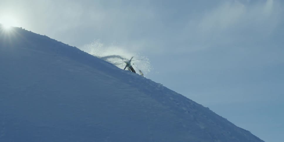 A skier jumps, spins, and crashes