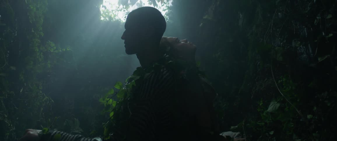 A man and woman are tied up with vines