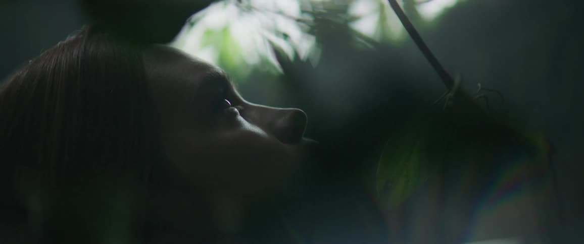 Vines are wrapped around a woman's face