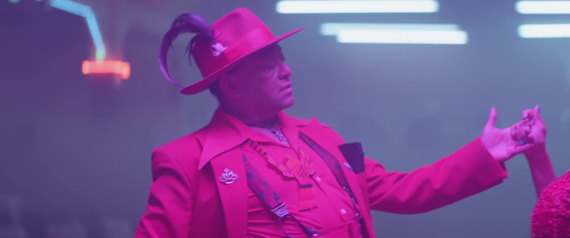 A man poses in a nightclub