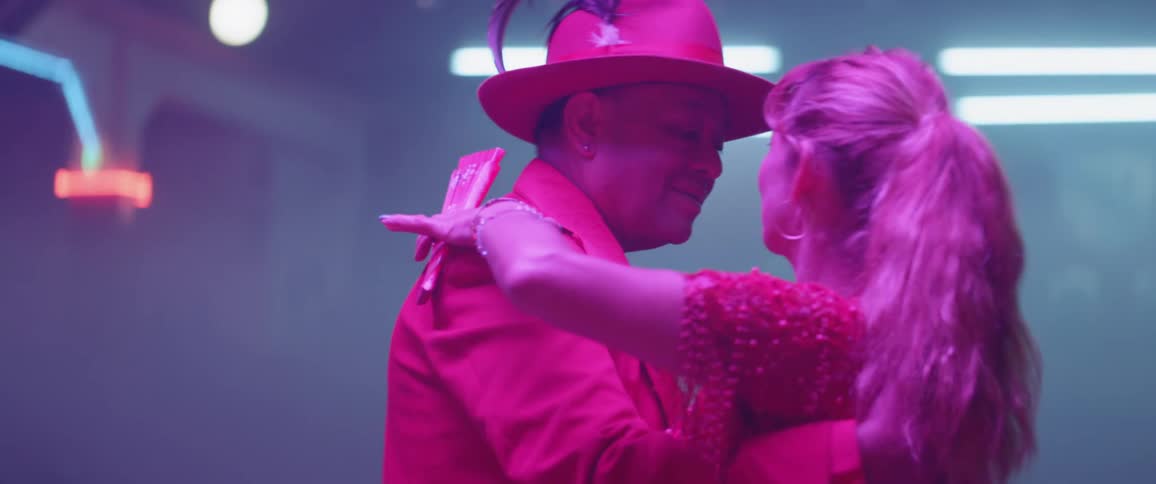Man and woman dance under the lights